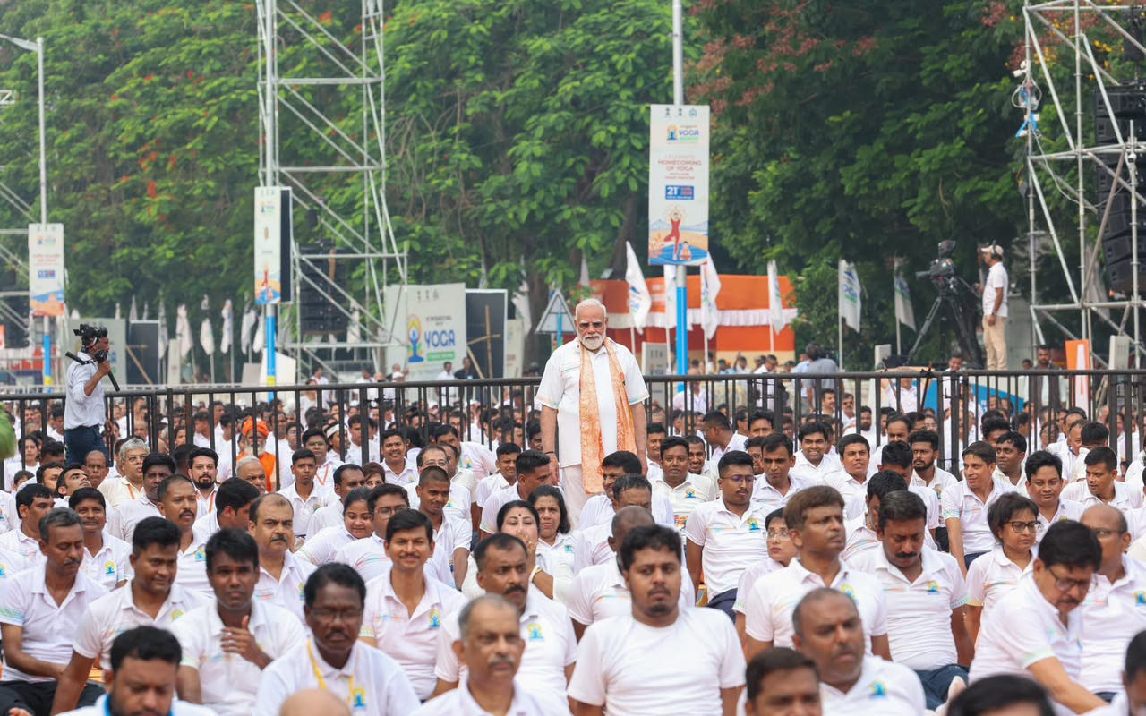 A sea of white — participants at the IDY 2026 mass yoga event.