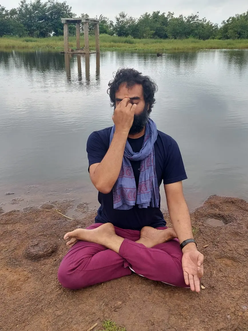 Naveen K. Kolli practising pranayama by a lake — Navyoga meditation